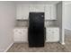 Kitchen with white cabinets and black refrigerator at 6849 Coventry Ridge Rd, Raleigh, NC 27616