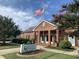 Brick building with American flag at 1724 Red Elm Lane, Homesite 76, Fuquay Varina, NC 27526