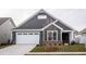 Gray house with white garage door and landscaping at 1724 Red Elm Lane, Homesite 76, Fuquay Varina, NC 27526