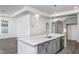 Modern kitchen with gray cabinets and island at 1724 Red Elm Lane, Homesite 76, Fuquay Varina, NC 27526
