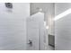 Clean shower with modern gray tile and glass enclosure at 1724 Red Elm Lane, Homesite 76, Fuquay Varina, NC 27526