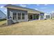 Gray exterior of the house with a backyard patio and lawn at 2209 Abbeyhill Dr # 118, Raleigh, NC 27610