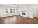 Living room featuring hardwood floors and a modern fireplace at 4738 Cypress Tree Ln, Raleigh, NC 27612