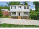 Two-story white house with black shutters, front porch, and driveway at 621 Bon Air Ave, Durham, NC 27704