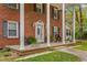 Inviting front porch with columns, rocking chairs, and planters at 3152 87 Hwy, Graham, NC 27253