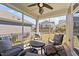 Relaxing screened porch with seating and ceiling fan at 495 Bramble Ln, Clayton, NC 27527