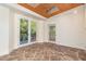 Sunroom featuring stone flooring and French doors leading to a deck at 107 Silo Dr, Chapel Hill, NC 27514