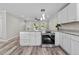 Modern kitchen with stainless steel appliances and white cabinets at 1016 Walnut St, Burlington, NC 27217