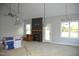 Living room featuring a fireplace, large windows, and modern light fixtures at 4303 Bragg Farm Ln, Franklinton, NC 27525