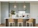Modern kitchen with island, light cabinets and pendant lighting at 2606 Marchmont St # 101, Raleigh, NC 27608
