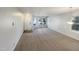 Open living room with neutral colored carpet and large window at 232 Pebblestone Dr, Durham, NC 27703