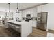Open concept kitchen with white cabinets, large island with seating, and stainless steel appliances at 708 Portia Way, Homesite 13, Morrisville, NC 27560