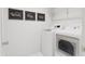 Convenient laundry room with washer, dryer, and overhead shelving at 708 Portia Way, Homesite 13, Morrisville, NC 27560