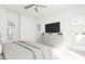 Main bedroom with dresser, tv, and access to bathroom and walk-in closet at 708 Portia Way, Homesite 13, Morrisville, NC 27560