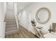 Spacious hallway with wood floors, and a large circular mirror at 708 Portia Way, Homesite 13, Morrisville, NC 27560