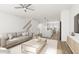 Open living space with hardwood floors and a view into the kitchen at 708 Portia Way, Homesite 13, Morrisville, NC 27560