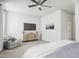 Spacious main bedroom with a dresser, TV, and comfortable seating at 710 Portia Way, Homesite 12, Morrisville, NC 27560