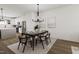 Modern dining room featuring a stylish table and chairs, adjacent to the kitchen at 710 Portia Way, Homesite 12, Morrisville, NC 27560