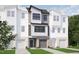 Modern three-story townhouse with two-car garage and landscaping at 710 Portia Way, Homesite 12, Morrisville, NC 27560