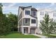 Modern 3-story townhome with gray siding at 712 Portia Way, Homesite 11, Morrisville, NC 27560