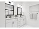 Elegant bathroom with double vanity, large mirrors, and modern fixtures at 712 Portia Way, Homesite 11, Morrisville, NC 27560
