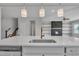 Kitchen island with sink, quartz countertop, and gold faucet; view of fireplace at 86 Walker Grove Ln, Lillington, NC 27546