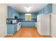 Bright kitchen with light blue cabinets and granite countertops at 1100 Water Oak Ct, Hillsborough, NC 27278