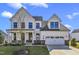 Two-story farmhouse with white siding, gray roof and a two-car garage at 616 Silver Comet Dr, Knightdale, NC 27545