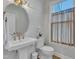 Modern powder room with white pedestal sink, gold fixtures, and geometric tile at 616 Silver Comet Dr, Knightdale, NC 27545