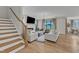 Open living area with fireplace, hardwood floors, and access to backyard at 616 Silver Comet Dr, Knightdale, NC 27545