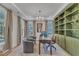 Bright home office with built-in shelves, a desk, and two armchairs at 616 Silver Comet Dr, Knightdale, NC 27545