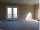 Spacious bedroom with French doors leading to a deck at 4874 Thom Rd, Mebane, NC 27302