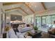 Open concept living room with high ceilings, exposed beams, and access to the kitchen at 1565 Bowers Store Rd, Siler City, NC 27344
