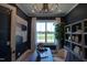 Bright home office features a large window, built-in shelving, and hardwood floors at 1565 Bowers Store Rd, Siler City, NC 27344