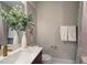 Elegant bathroom with a white sink, dark vanity, and gold accents at 1565 Bowers Store Rd, Siler City, NC 27344