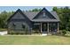 Modern farmhouse exterior with dark siding at 1565 Bowers Store Rd, Siler City, NC 27344