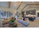 Open concept living room with high ceilings, exposed beams, and access to the kitchen at 1565 Bowers Store Rd, Siler City, NC 27344