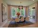 Elegant dining room with hardwood floors, large windows, and modern light fixture at 1565 Bowers Store Rd, Siler City, NC 27344