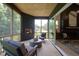 Cozy screened porch features a fireplace and plenty of seating at 1565 Bowers Store Rd, Siler City, NC 27344
