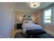 Charming bedroom with light walls, comfortable bedding, and a cozy sitting area at 1565 Bowers Store Rd, Siler City, NC 27344