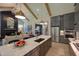 Open kitchen with island and stainless steel appliances, overlooking living room at 1565 Bowers Store Rd, Siler City, NC 27344