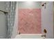 Spa-like bathroom with pink herringbone tile and a relaxing bathtub at 1565 Bowers Store Rd, Siler City, NC 27344
