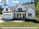 Stunning farmhouse exterior with white siding and two-car garage at 3806 River Mill Ln, Franklinton, NC 27525