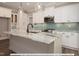 Modern kitchen with white cabinets, granite countertops, and a large island at 3806 River Mill Ln, Franklinton, NC 27525