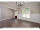 Elegant dining room with hardwood floors, wainscoting, and chandelier at 3806 River Mill Ln, Franklinton, NC 27525
