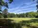 Wooded lot with a large, open field and mature trees at 3806 River Mill Ln, Franklinton, NC 27525