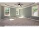 Spacious bedroom with ceiling fan and large windows at 3806 River Mill Ln, Franklinton, NC 27525