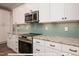 Modern kitchen with stainless steel appliances and light teal backsplash at 3806 River Mill Ln, Franklinton, NC 27525