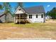 Home with a large deck and screened porch, overlooking a spacious backyard at 3806 River Mill Ln, Franklinton, NC 27525