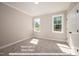 Bright bedroom with carpet and two windows at 3806 River Mill Ln, Franklinton, NC 27525